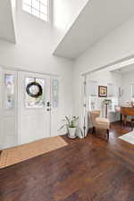 Entrance foyer featuring dark wood-type flooring