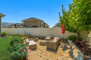 View of patio featuring a mountain view and an outdoor living space with a fire pit