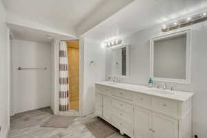 Bathroom featuring vanity, a textured ceiling, and a shower with curtain