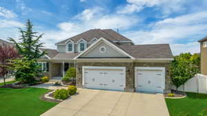 Craftsman-style home featuring a garage and a front yard