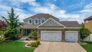 Craftsman house with a garage, covered porch, and a front lawn