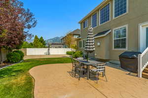 View of patio with a mountain view and area for grilling