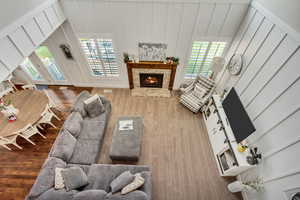 Living room with hardwood / wood-style flooring and a brick fireplace