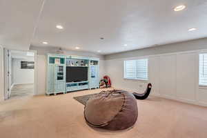 Interior space with light colored carpet and a healthy amount of sunlight