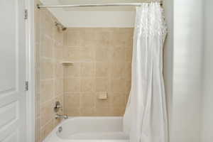 Bathroom featuring shower / bath combo with shower curtain