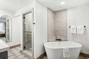 Bathroom with vanity and independent shower and bath