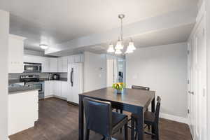 Dining room featuring dark hardwood / wood-style floors and a chandelier