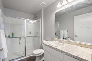 Bathroom featuring walk in shower, vanity, toilet, and wood-type flooring