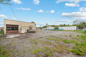 View of yard with a garage and an outdoor structure