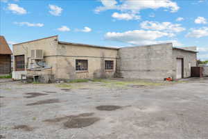 View of side of property featuring a garage and cooling unit