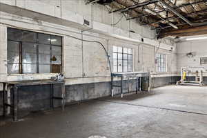 Interior space with a towering ceiling and concrete floors