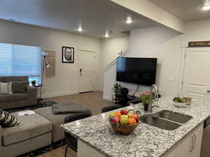 Living room with sink and hardwood / wood-style floors