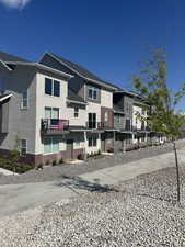 View of front of home with brick siding, a residential view, and stucco siding
