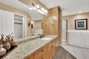 Primary bathroom featuring separate shower and walk-in tub