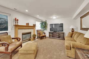 Basement family room featuring a gas fireplace and extra daylight.