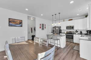 Dining area featuring sink, heating unit, and light hardwood / wood-style floors