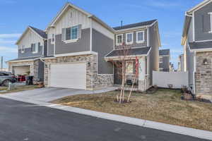 View of front of property with a garage and a front yard