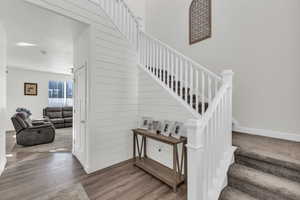 Stairs featuring wood-type flooring