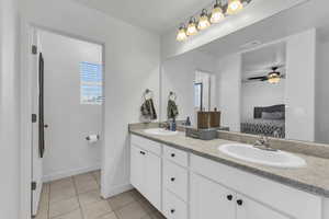 Bathroom with ceiling fan, tile patterned floors, and vanity