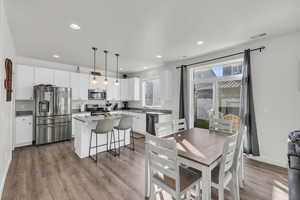 Dining area with sink and light hardwood / wood-style flooring