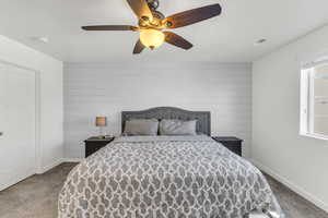 Bedroom with light colored carpet and ceiling fan