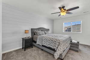 Carpeted bedroom featuring ceiling fan