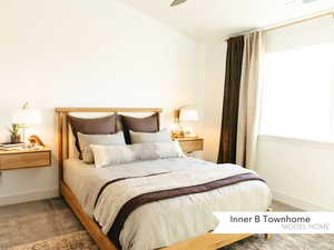 Carpeted bedroom with ceiling fan and lofted ceiling