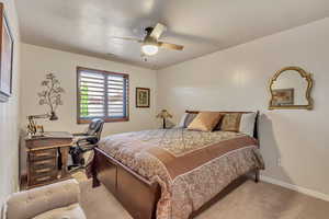 Bedroom with light carpet and ceiling fan