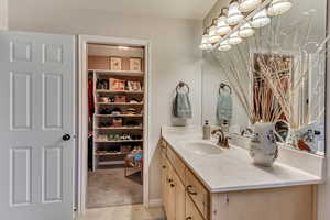 Bathroom featuring vanity and an inviting chandelier