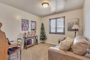 Sitting room with light colored carpet