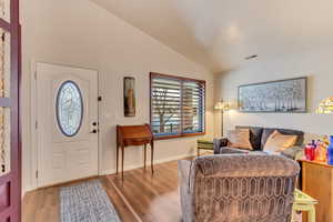 Entryway featuring vaulted ceiling and hardwood / wood-style floors