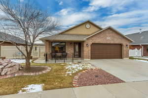 View of front of house featuring a garage and covered porch