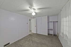 Unfurnished bedroom with carpet flooring and ceiling fan