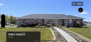 Ranch-style house featuring a front yard