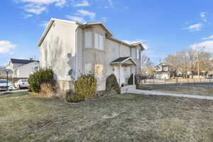 View of side of property with a yard