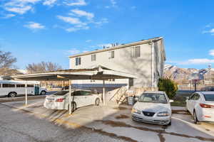 View of vehicle parking featuring a mountain view and a carport