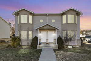 View of front of property with a yard