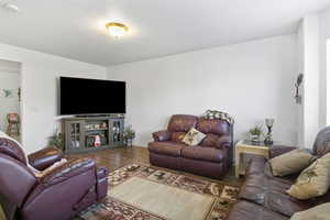 Living room with hardwood / wood-style flooring