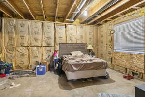 Bedroom featuring concrete flooring