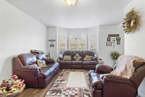 Living room with hardwood / wood-style flooring