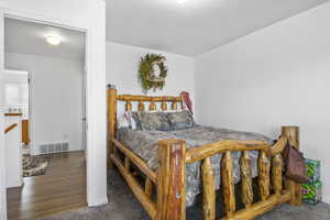 Bedroom featuring dark carpet