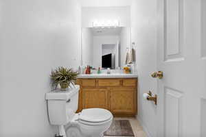 Bathroom with tile patterned floors, vanity, and toilet