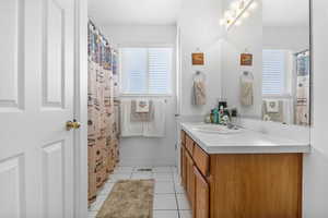 Bathroom featuring tile patterned flooring and vanity