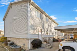 View of side of property featuring central AC unit