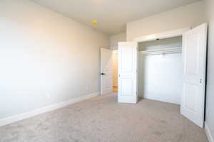 Bedroom 2 featuring a closet and light carpet