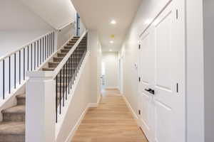 Hallway featuring light waterproof luxury vinyl plank flooring