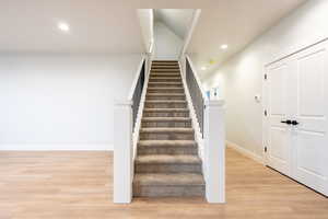 Carpeted Staircase featuring light waterproof luxury vinyl plank flooring