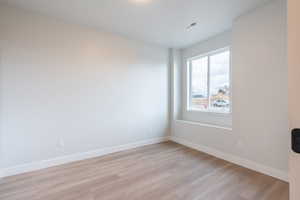 Bedroom 1 with light waterproof luxury vinyl plank flooring