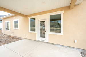 Property entrance with a patio