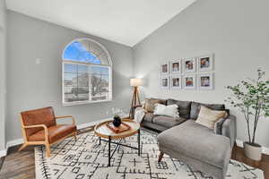 Living room with vaulted ceiling and light wood-type flooring